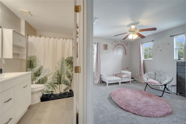 325 Aldridge Ln, Davenport, FL 33897 - bathroom with vanity, a ceiling fan, a textured ceiling, toilet, and curtained shower