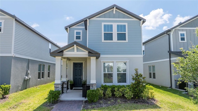 12133 Bracco St, Winter Garden, FL 34787 - view of front of home featuring a front yard, board and batten siding, and stucco siding