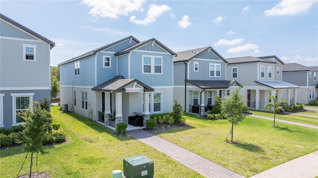 12133 Bracco St, Winter Garden, FL 34787 - multi unit property with board and batten siding, a front yard, a residential view, and stucco siding