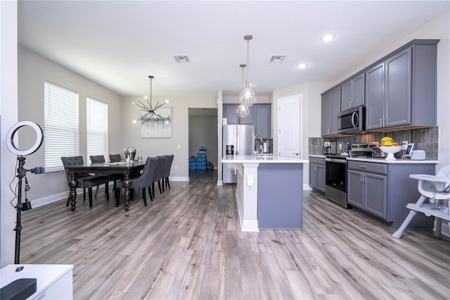 12133 Bracco St, Winter Garden, FL 34787 - kitchen featuring appliances with stainless steel finishes, light countertops, baseboards, gray cabinets, and recessed lighting