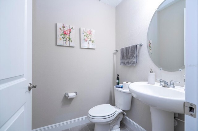 12133 Bracco St, Winter Garden, FL 34787 - half bathroom with toilet, tile patterned floors, and baseboards