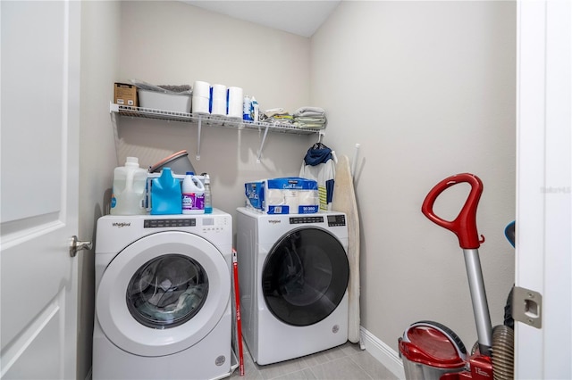 12133 Bracco St, Winter Garden, FL 34787 - clothes washing area featuring washer and dryer, light tile patterned floors, and baseboards