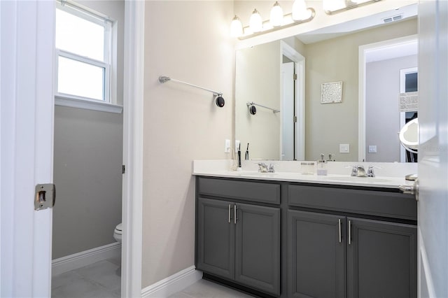 12133 Bracco St, Winter Garden, FL 34787 - full bath featuring toilet, double vanity, baseboards, and tile patterned floors