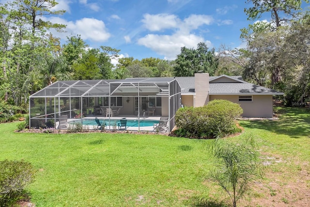303 S Sweetwater Blvd, Longwood, FL 32779 - rear view of house featuring a lawn, an outdoor pool, a chimney, and view of scattered trees