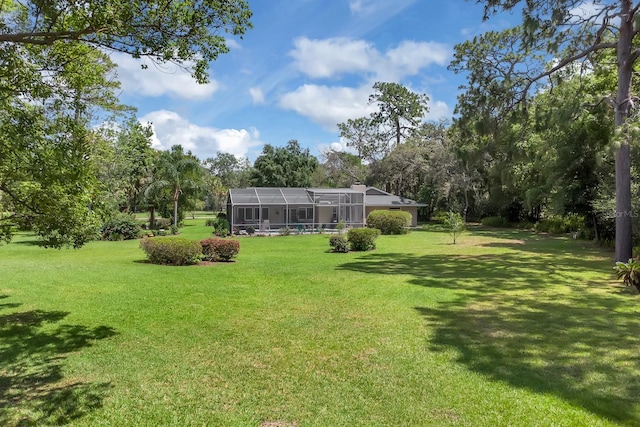 303 S Sweetwater Blvd, Longwood, FL 32779 - view of green lawn with view of wooded area and glass enclosure