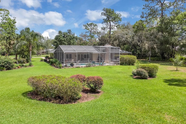 303 S Sweetwater Blvd, Longwood, FL 32779 - rear view of house featuring a lawn, an outdoor pool, glass enclosure, a chimney, and view of wooded area