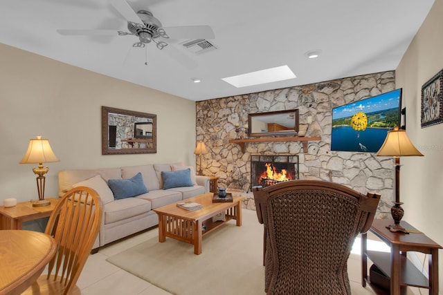 303 S Sweetwater Blvd, Longwood, FL 32779 - living room featuring a skylight, a stone fireplace, a ceiling fan, and light tile patterned flooring