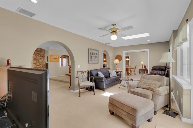 303 S Sweetwater Blvd, Longwood, FL 32779 - living room with light colored carpet, arched walkways, a ceiling fan, and baseboards