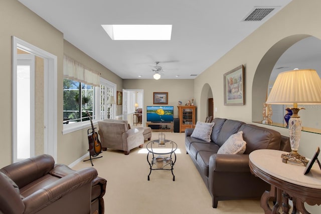 303 S Sweetwater Blvd, Longwood, FL 32779 - carpeted living room featuring arched walkways, a skylight, and ceiling fan