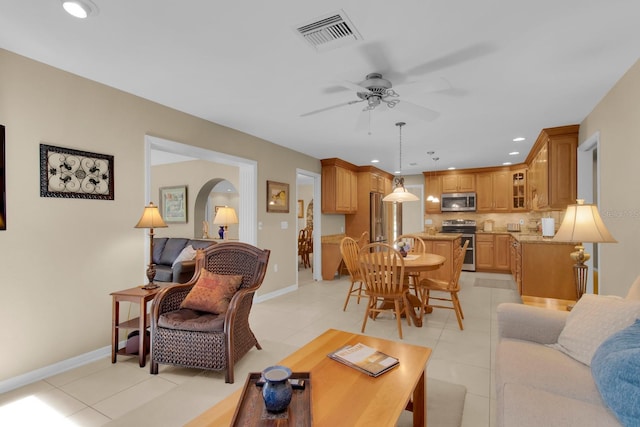 303 S Sweetwater Blvd, Longwood, FL 32779 - living room featuring light tile patterned flooring, a ceiling fan, recessed lighting, arched walkways, and baseboards