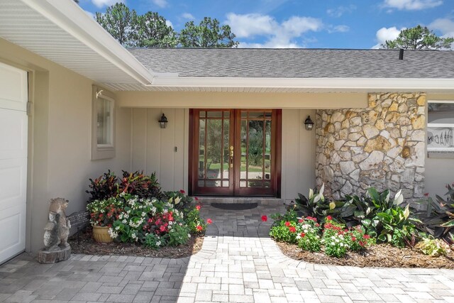 303 S Sweetwater Blvd, Longwood, FL 32779 - entrance to property with french doors, a shingled roof, and stone siding