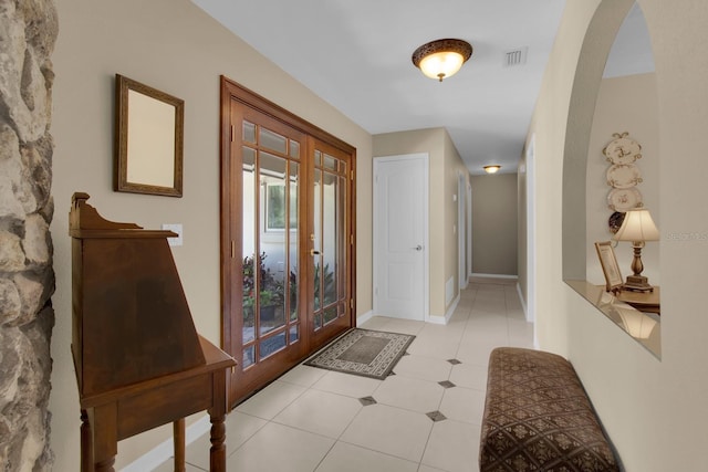 303 S Sweetwater Blvd, Longwood, FL 32779 - foyer with french doors, light tile patterned flooring, arched walkways, and baseboards