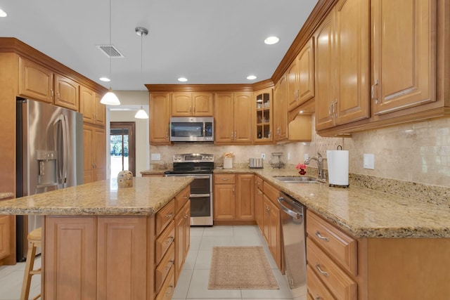 303 S Sweetwater Blvd, Longwood, FL 32779 - kitchen featuring appliances with stainless steel finishes, a sink, light stone counters, light tile patterned flooring, and recessed lighting