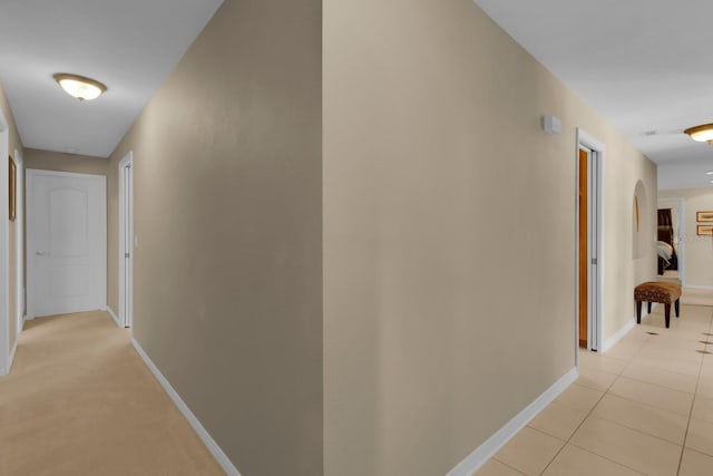 303 S Sweetwater Blvd, Longwood, FL 32779 - corridor featuring baseboards, arched walkways, and light tile patterned floors