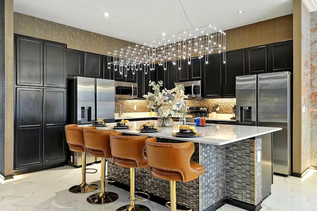 4441 Ganesha Loop, Kissimmee, FL 34746 - kitchen featuring stainless steel appliances, dark cabinetry, light marble finish floors, tasteful backsplash, and recessed lighting