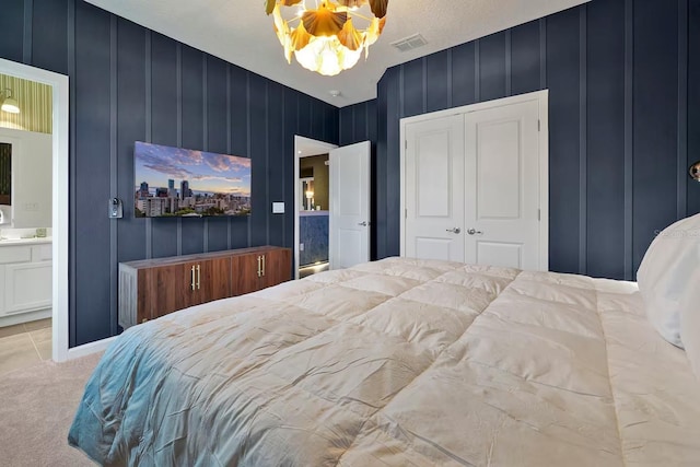 4441 Ganesha Loop, Kissimmee, FL 34746 - carpeted bedroom with a closet, ensuite bathroom, and a decorative wall
