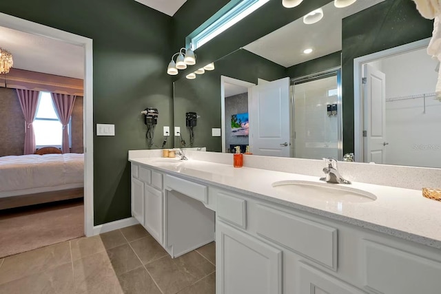 4441 Ganesha Loop, Kissimmee, FL 34746 - bathroom with a stall shower, double vanity, tile patterned floors, and baseboards