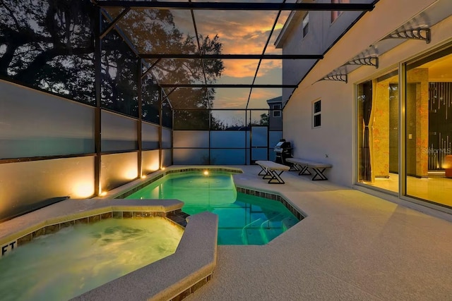 4441 Ganesha Loop, Kissimmee, FL 34746 - pool at dusk with a pool with connected hot tub, a patio area, area for grilling, and glass enclosure