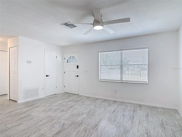 1113 Leeward Dr, Deltona, FL 32738 - unfurnished room featuring a ceiling fan, a textured ceiling, and baseboards