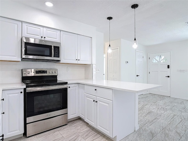 1113 Leeward Dr, Deltona, FL 32738 - kitchen featuring stainless steel appliances, light marble finish flooring, a peninsula, light countertops, and white cabinetry