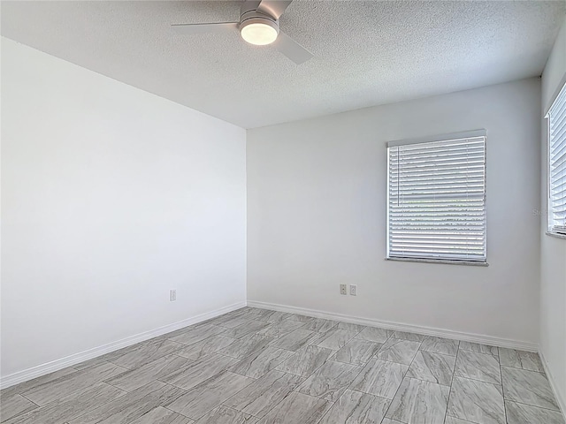 1113 Leeward Dr, Deltona, FL 32738 - spare room featuring ceiling fan, a textured ceiling, and baseboards