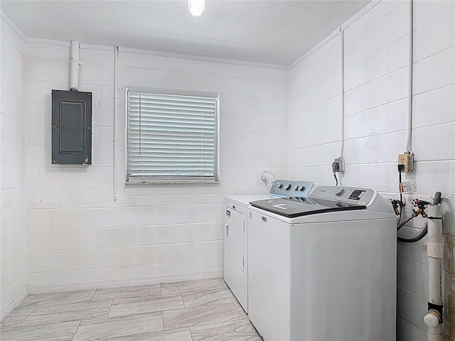 1113 Leeward Dr, Deltona, FL 32738 - clothes washing area with washing machine and clothes dryer, electric panel, and a textured ceiling