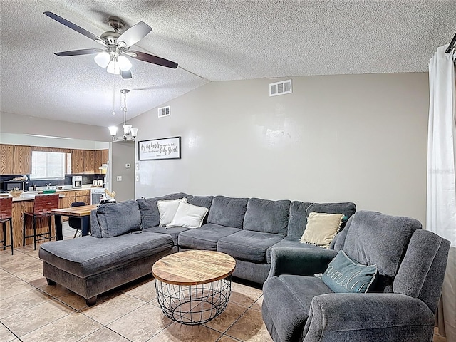 1803 Foxhall Cir Unit 1803, Kissimmee, FL 34741 - living area featuring light tile patterned floors, a textured ceiling, lofted ceiling, and a ceiling fan