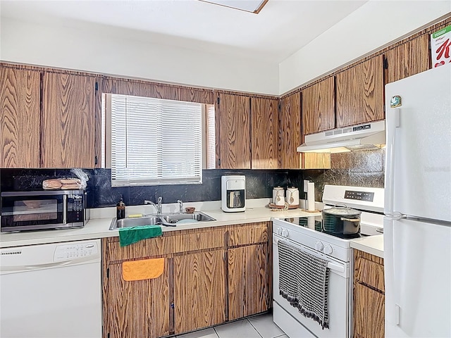 1803 Foxhall Cir Unit 1803, Kissimmee, FL 34741 - kitchen featuring white appliances, under cabinet range hood, a sink, and light countertops
