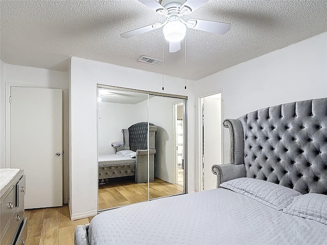 1803 Foxhall Cir Unit 1803, Kissimmee, FL 34741 - bedroom featuring light wood finished floors, a closet, a textured ceiling, and ceiling fan