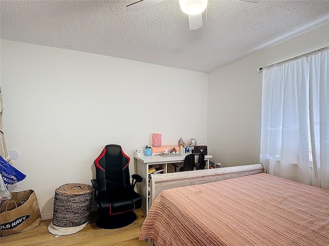 1803 Foxhall Cir Unit 1803, Kissimmee, FL 34741 - bedroom with wood finished floors, ceiling fan, and a textured ceiling