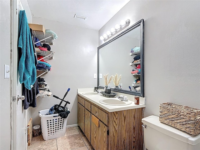 1803 Foxhall Cir Unit 1803, Kissimmee, FL 34741 - bathroom featuring double vanity, toilet, and tile patterned floors