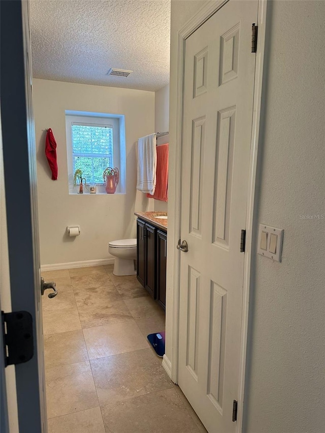 10148 Malpas Pt, Orlando, FL 32832 - bathroom featuring vanity, toilet, a textured ceiling, and baseboards