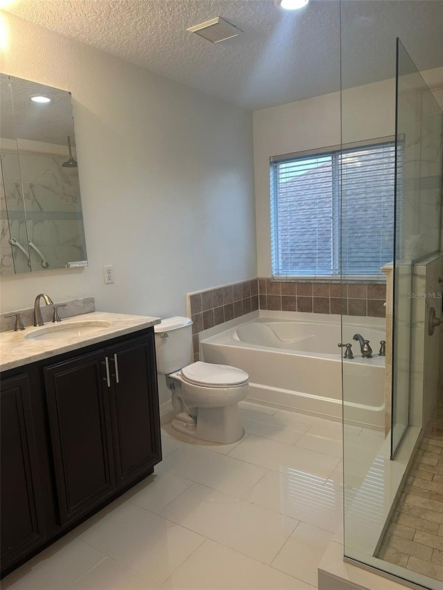 10148 Malpas Pt, Orlando, FL 32832 - bathroom featuring a stall shower, a bath, a textured ceiling, vanity, and toilet
