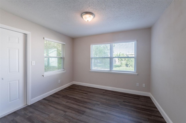 4226 Kelly Miller Ct, Orlando, FL 32811 - spare room with dark wood-style flooring, a textured ceiling, and baseboards
