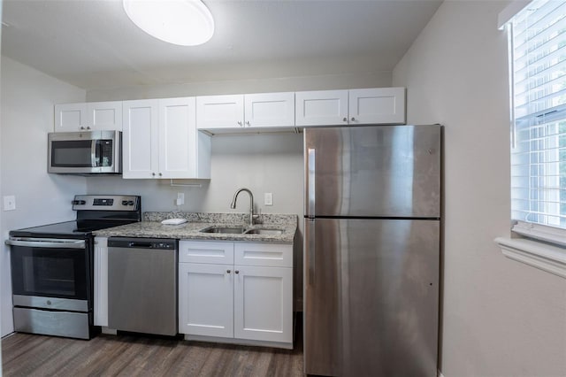 4226 Kelly Miller Ct, Orlando, FL 32811 - kitchen featuring stainless steel appliances, a sink, dark wood-style flooring, and white cabinets