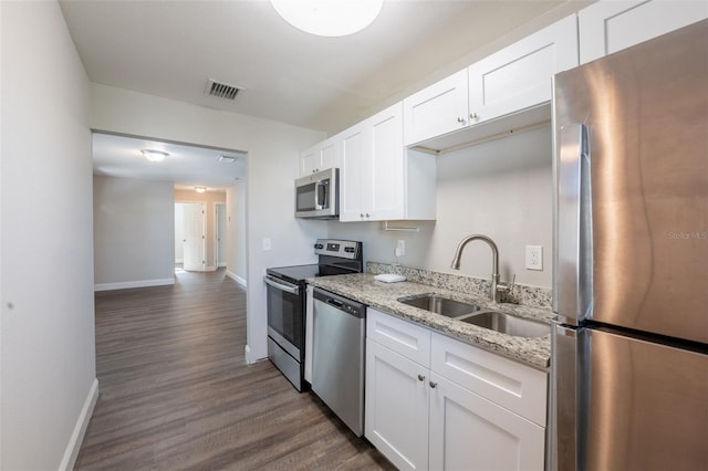 4226 Kelly Miller Ct, Orlando, FL 32811 - kitchen with appliances with stainless steel finishes, a sink, baseboards, and dark wood-type flooring