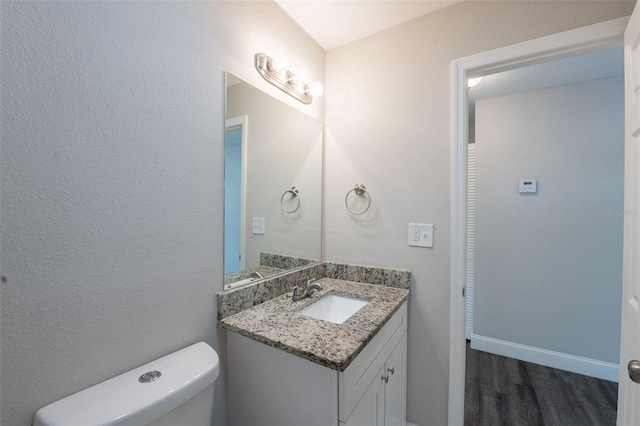 4226 Kelly Miller Ct, Orlando, FL 32811 - bathroom featuring vanity, wood finished floors, toilet, and baseboards