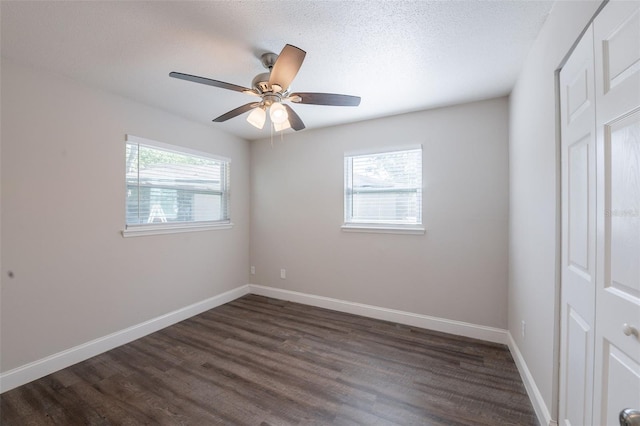 4226 Kelly Miller Ct, Orlando, FL 32811 - unfurnished bedroom featuring dark wood finished floors, baseboards, a textured ceiling, and ceiling fan