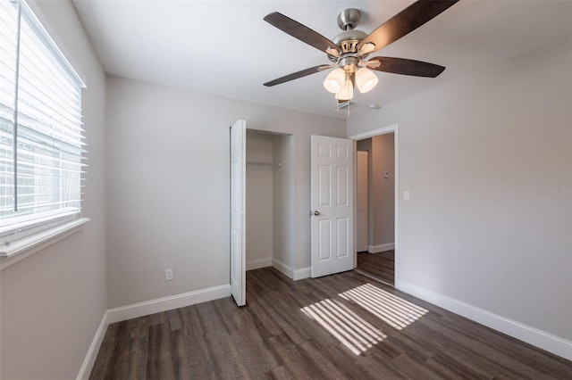 4226 Kelly Miller Ct, Orlando, FL 32811 - unfurnished bedroom with multiple windows, wood finished floors, baseboards, and a closet