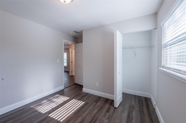 4226 Kelly Miller Ct, Orlando, FL 32811 - unfurnished bedroom with a closet, wood finished floors, and baseboards