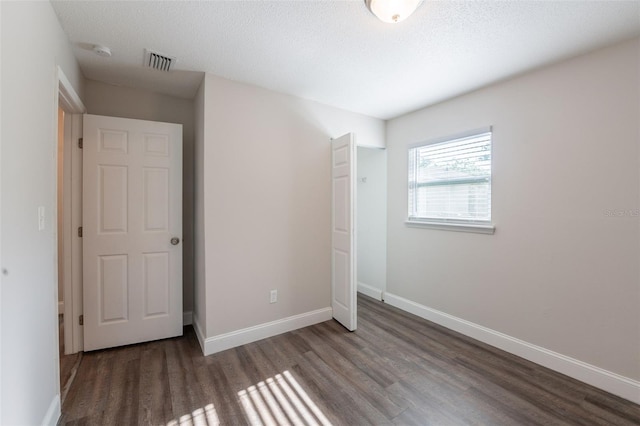 4226 Kelly Miller Ct, Orlando, FL 32811 - unfurnished bedroom featuring wood finished floors, baseboards, a closet, and a textured ceiling