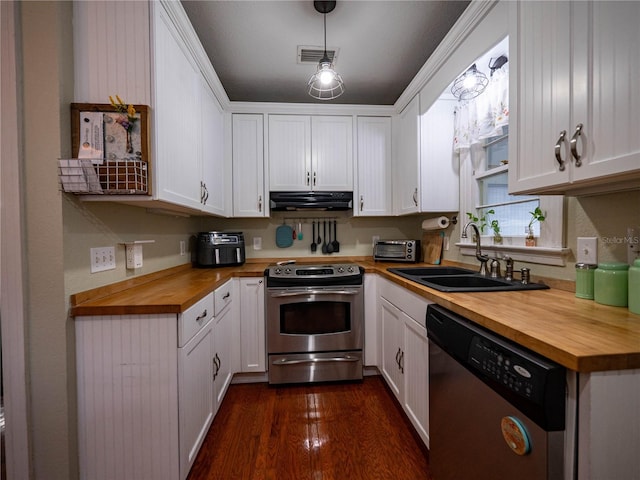 1102 S Oak Ave, Sanford, FL 32771 - kitchen with wood counters, appliances with stainless steel finishes, a sink, extractor fan, and white cabinetry