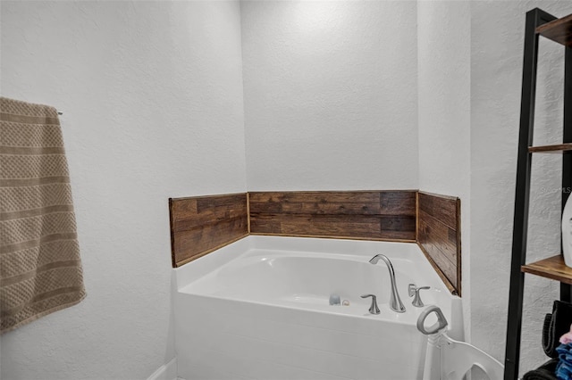 503 Meadow Pointe Dr, Haines City, FL 33844 - full bathroom featuring a garden tub and a textured wall