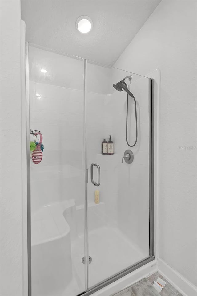 503 Meadow Pointe Dr, Haines City, FL 33844 - bathroom with a shower stall and baseboards