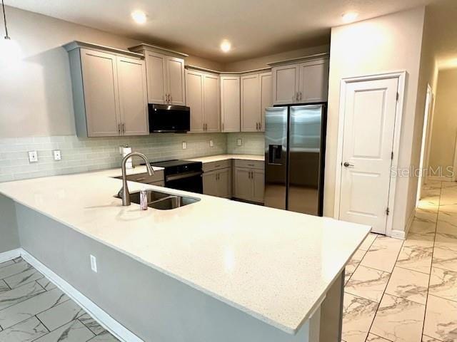 1513 Maidstone Ct, Davenport, FL 33896 - kitchen with stainless steel fridge, light marble finish floors, gray cabinetry, and recessed lighting