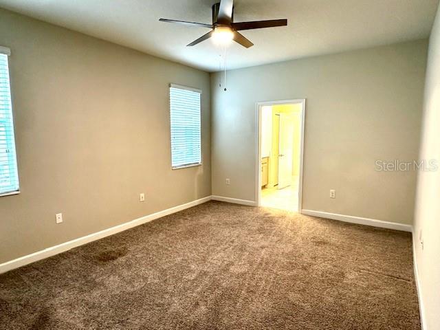 1513 Maidstone Ct, Davenport, FL 33896 - unfurnished room featuring a ceiling fan, carpet floors, and healthy amount of natural light