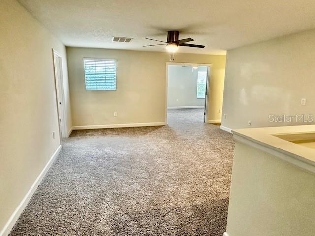 1513 Maidstone Ct, Davenport, FL 33896 - carpeted empty room with ceiling fan and baseboards