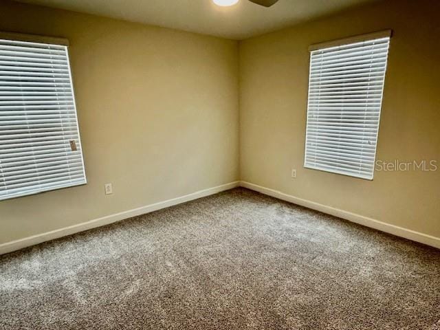 1513 Maidstone Ct, Davenport, FL 33896 - spare room featuring baseboards, carpet floors, ceiling fan, and plenty of natural light