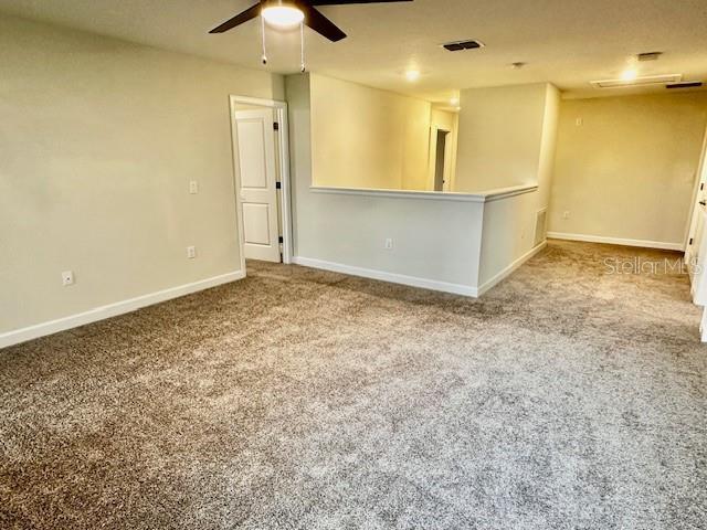 1513 Maidstone Ct, Davenport, FL 33896 - unfurnished room featuring a ceiling fan, carpet flooring, and baseboards