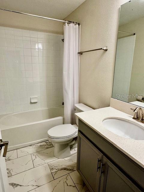 1513 Maidstone Ct, Davenport, FL 33896 - full bathroom with marble look tiles, toilet, shower / tub combo, and vanity